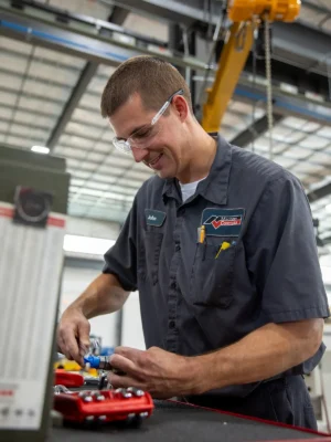 Employee smiling while working on parts
